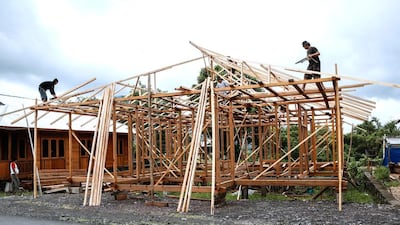 Woloan workers contruct a prefabricated wooden house. Orders have arrived from as far away as Argentina, Norway, Poland, Japan, South Korea, the Philippines and the United States for these simple traditional wooden houses. Putu Sayoga / Getty Images