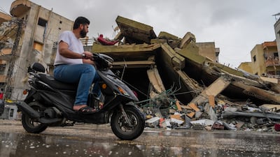 A man rides by a building that was damaged by an Israeli air strike in Nabatieh on the second day of a ceasefire between Israel and Lebanon. Getty
