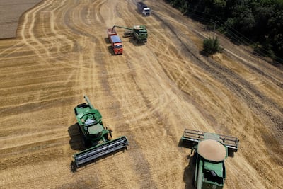 Farmers harvest with their combines in a wheat field near the village Tbilisskaya, Russia, a country that, along with Ukraine, grows much of the world's wheat. AP Photo