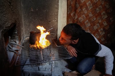 A Palestinian man lights a fire in Deir Al Balah, in the central Gaza Strip. Reuters