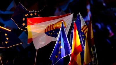 Spanish and European flags wave during a campaign meeting for the Catalan regional election. Pau Barrena / AFP