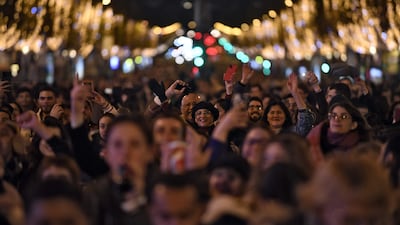 People cheer as the lights come on. AFP