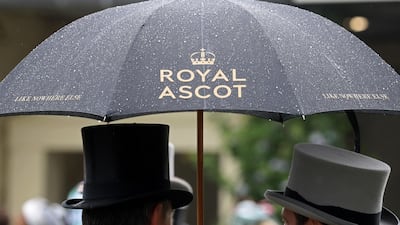 Racegoers talk under an umbrella on day two of Royal Ascot at Ascot Racecourse in Ascot, England. Getty Images