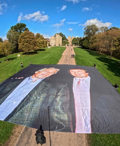 Activists unfurl a large banner depicting US President Donald Trump posing with Jeffrey Epstein, on the Long Walk, outside Windsor Castle. AFP