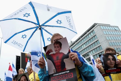 Pro-Israeli demonstrators hold up pictures of victims of Hamas violence outside the International Court of Justice in The Hague. Reuters