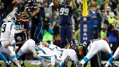 Kam Chancellor, No 31, blocks Graham Gano, No 9, of the Panthers but gets called for roughing the kicker last week. Otto Greule Jr / AFP