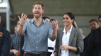 Prince Harry and Meghan react as they look out towards the heavy rain and storm as they visit the Clontarf Foundation and Girls Academy at Dubbo College on October 17, 2018 in Dubbo, Australia. Getty Images