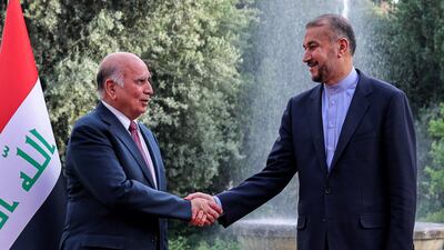 Iran's Foreign Minister Hossein Amir Abdollahian, right, receives his Iraqi counterpart Fuad Hussein during a welcome ceremony in the capital Tehran on April 13, 2022. AFP