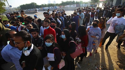 Spectators line up to enter the National Stadium in Karachi. EPA