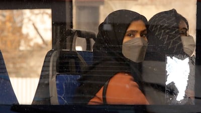 Women travel on a bus in Tehran, Iran. Coronavirus infections have surged in the country in recent weeks. Photo: EPA