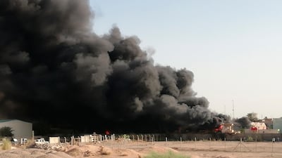 Smoke rises from a fire that broke out at Baghdad's largest ballot box storage site, where ballots from Iraq's May parliamentary elections are stored, in Baghdad, Iraq, on Sunday, June 10, 2018. Hadi Mizban / AP Photo