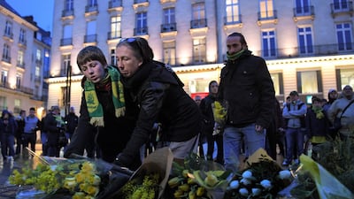 Nantes supporters lay flowers. AFP