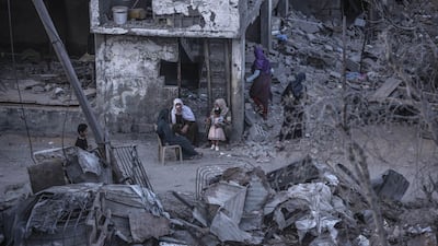 Palestinians sit amid the rubble of destroyed homes in Beit Hanoun, northern Gaza, on May 22, 2021. Getty