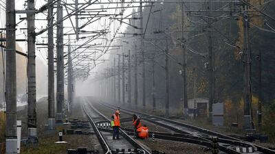 Workers in Kannelyarvi inspect the new high speed rail link to Finland. Alexander Demianchuk / Reuters