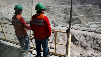 Workers stand over BHP Billiton's Escondida, the world's biggest copper mine, in Antofagasta, Chile. Reuters