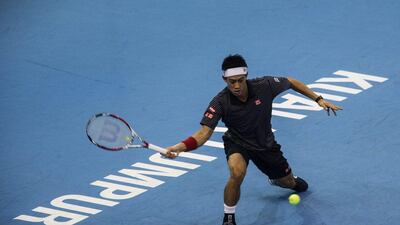 Kei Nishikori of Japan returns a shot to Julien Benneteau (unseen) of France during the final at the ATP Malaysian Open, which Nishikori won, on Sunday in Kuala Lumpur. Ahmad Yusni / EPA / September 28, 2014