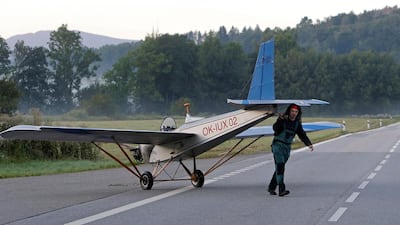 Mr Hadrava escorts Vampira across a nearby road. David W Cerny / Reuters