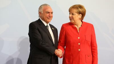 German Chancellor Angela Merkel greets Brazil's president Michel Temer. Ludovic Marin / AFP Photo