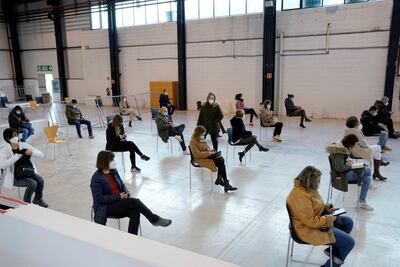 Healthcare professionals rest after taking injections of the Pfizer-BioNTech in Pamplona, Spain. Reuters