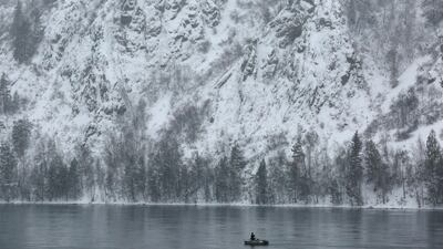 A man fishes from a boat on the Yenisei River outside the Siberian city of Krasnoyarsk, Russia. Ilya Naymushin / Reuters