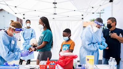 People receive Covid-19 antibody tests during a free testing session in honour of Dr. Martin Luther King, Jr. at Southside Church of Christ in Los Angeles. AP Photo