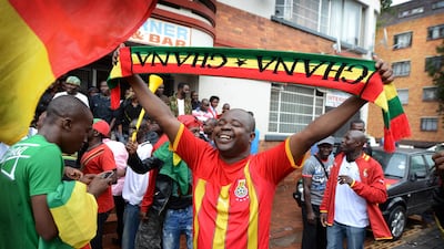 A Ghana supporter in Yeoville waves his scarf with his side up 1-0 at half time. Photo: Bram Lammers