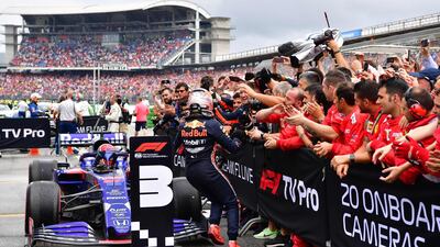 Kvyat runs to celebrate with his Toro Rosso mechanics. AFP