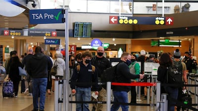 People queue at a security checkpoint at Seattle-Tacoma International Airport in Washington. Reuters