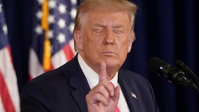 US President Donald Trump gestures after signing executive orders for economic relief during a news conference at his golf resort in Bedminster, New Jersey, US. Reuters