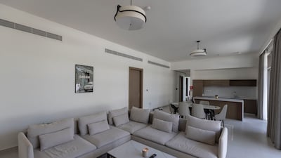 The living room and dining area with show kitchen