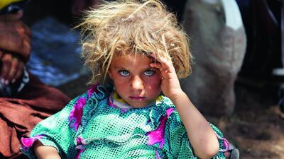 A girl from the minority Yazidi sect rests after fleeing violence in Sinjar, in this August 13 file photo. Youssef Boudlal / Reuters