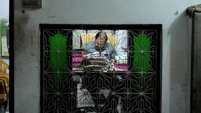 Managing Director of The New Sarkar Bidi Factory, Quazi Naseem Ahmed, works in his office.