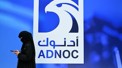 A guest at Adnoc's stand at Adipec in Abu Dhabi. AFP