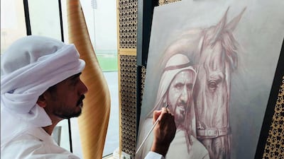 Emirati artist Saggaf Al Hashemi works on a painting during the launch event in Dubai.