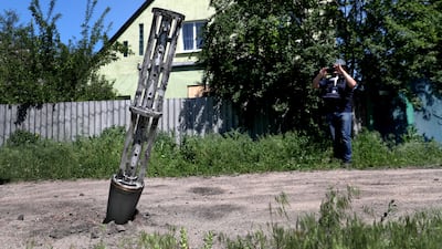 An empty cluster munition container stuck in the ground after a military strike on the outskirts of Kharkiv, Ukraine. Reuters