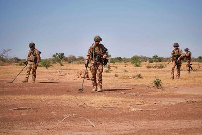 In this file photo taken on November 12, 2019 soldiers from the French Army holds detectors while searching for the presence of IED (Improvised Explosive Devices) during the Burkhane Operation in northern Burkina Faso. AFP
