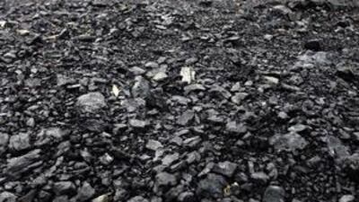 Excavators move coal for shipping at a processing area in East Kalimantan in Indonesia.