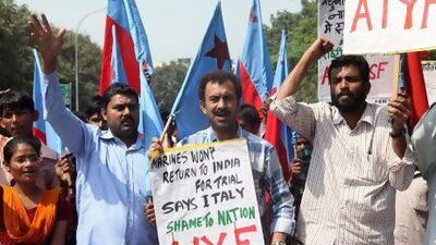 Indians gather outside the Italian embassy in New Delhi to protest against Italy’s refusal to return two of their marines to face trial.