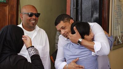 Morne and Celeste Nurse hug outside of court in Cape Town after a judge handed a 10-year jail sentence to a woman who kidnapped their newborn girl almost 20 years ago. Schalk van Zuydam / AP Photo
