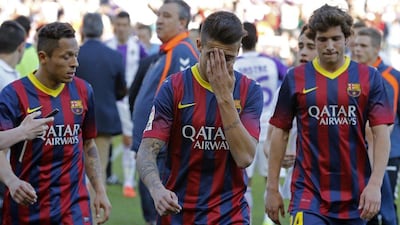 Barcelona's Brazilian defender Adriano, left, Barcelona's forward Cristian Tello and Barcelona's midfielder Sergi Roberto react at the end of the Spanish league football match Valladolid vs FC Barcelona at the Jose Zorilla stadium in Valladolid on March 8, 2014. Valladolid won 1-0. AFP PHOTO/ CESAR MANSO