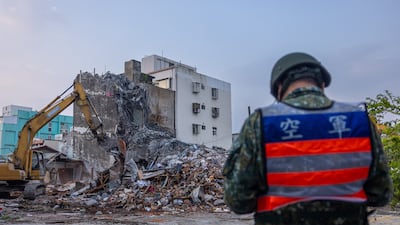 Rescue teams demolish a collapsed building following the earthquake. Getty Images