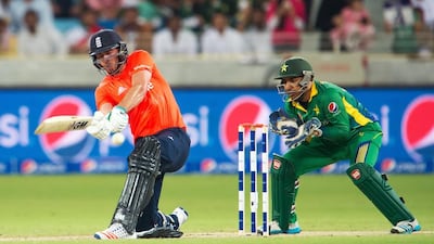England's James Vince (L) plays a shot while Pakistan's wicket keeper Sarfraz Ahmed watches during the second T20 cricket match between Pakistan and England at the Dubai International Cricket Stadium in Dubai on November 27, 2015. AFP PHOTO / INEKE ZONDAG