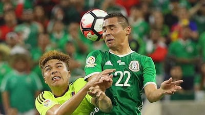 Adalberto Penaranda of Venezuela, left, fights for the ball with Paul Aguilar of Mexico. Scott Halleran / Getty Images