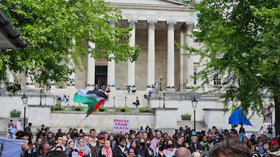 Students held banners telling University College London to 'divest from death' and calling it complicit in genocide. Tim Stickings / The National