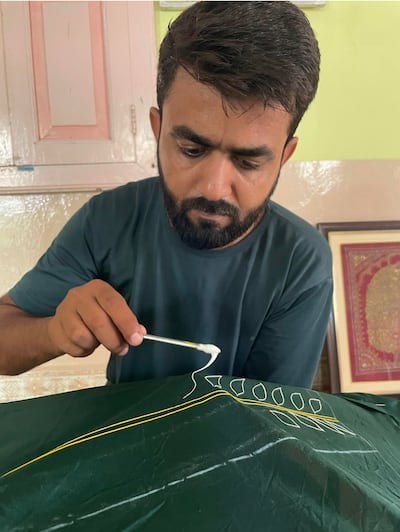 Mohammed Jabbar Khatri at work creating a rogan pattern with an iron stylus. Photo: Mohammed Jabbar Khatri