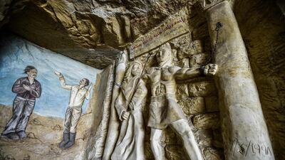 This picture taken shows a view of a relief sculpture made by Polish artist Mario at the St. Simon the Tanner Monastery complex in the Egyptian capital Cairo's eastern hillside Mokattam district, depicting the torture of the Old Testament Biblical figure Samson at the hands of the Philistines according to the Book of Judges. Mario spent more than two decades carving the rugged insides of the seven cave churches and chapels of the rock-hewn St. Simon Monastery and church complex atop Cairo's Mokattam hills, with designs inspired by biblical stories. It was all done to fulfil the wishes of the church's parish priest who met Mario in the early 1990s in Cairo. The Polish artist, who had arrived in Egypt earlier on an educational mission, was then looking for an opportunity to serve God at the monastery. AFP
