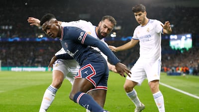 PSG's Nuno Mendes in action with Real Madrid's Dani Carvajal and Marco Asensio. Reuters