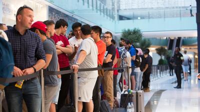 Customers in Dubai Mall queued through the night to be one of the first to get their hands on Apple's new iPhones. Leslie Pableo / The National