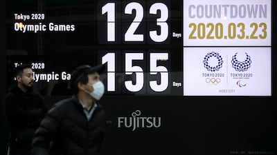 A man walks near a countdown display for the Tokyo 2020 Olympics and Paralympics in Tokyo on Monday. AP