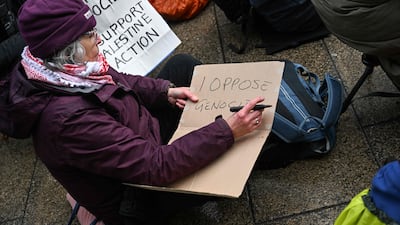 A protester writes out a placard in Leeds. AFP